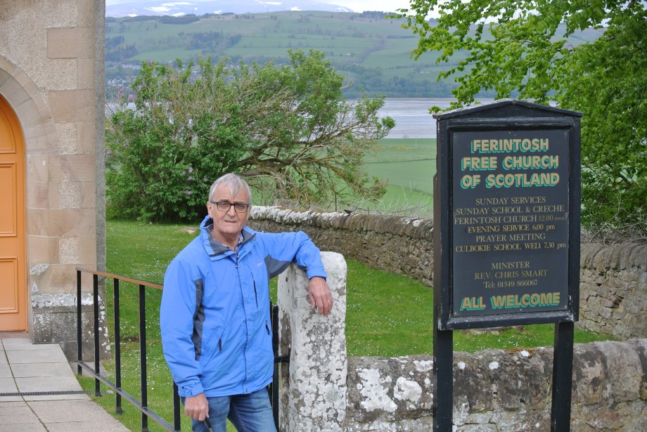 Hamish outside Ferintosh Free Church. Beyond lies Cromarty Firth and Dingwall.